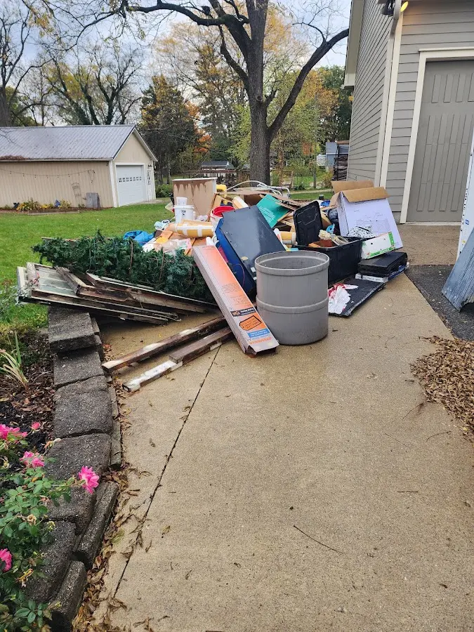 Dumpster being loaded with debris for Estate Cleanout Dumpster Rental in Spencer